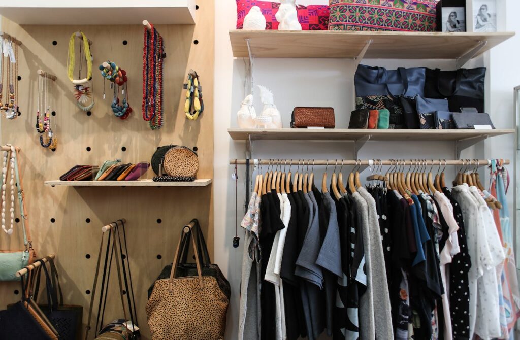 Neatly arranged clothing and accessories in a stylish wardrobe setup.